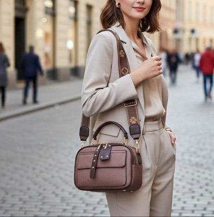 Woman holding a brown handbag on a city street